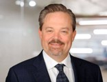 A person in a suit and tieAI-generated content may be incorrect.